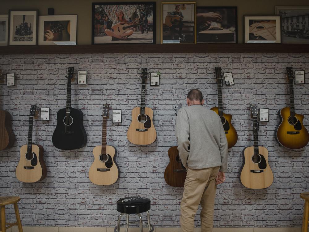 A visitor looks at guitars at the Martin Guitar factory in Nazareth, PA, on Tuesday October 15 2024.