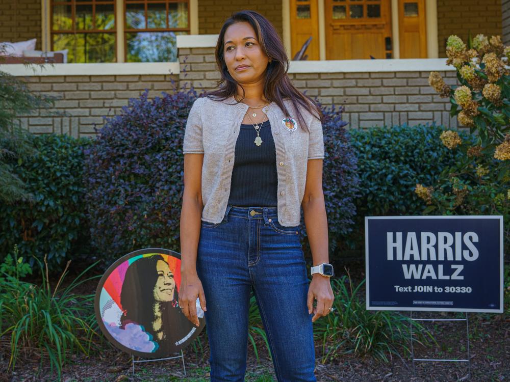 Tahmida Shamsuddin stands for a portrait outside of her home in Atlanta. Knocking on doors of strangers to talk about the election can be anxiety-inducing, she said.