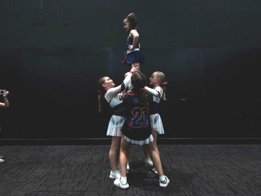 A young cheerleader takes a photo of her teammates practicing during the Frost Extreme cheerleading event in Wilmington, Delaware, on January 29, 2023. The majority of cheerleaders are girls aged 6-17.