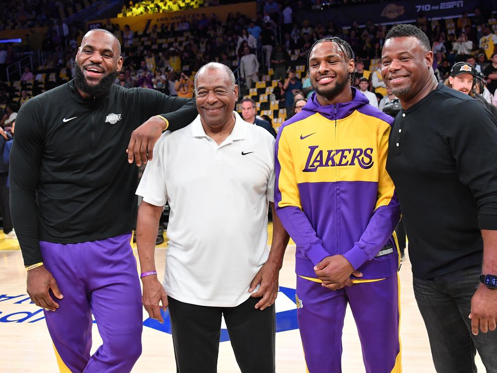 LeBron James, Ken Griffey Sr., Bronny James and Ken Griffey Jr. pose for a photo on Tuesday, when the Jameses became the first father-son pair to play together in the NBA. The Griffeys hold that same distinction in the MLB.