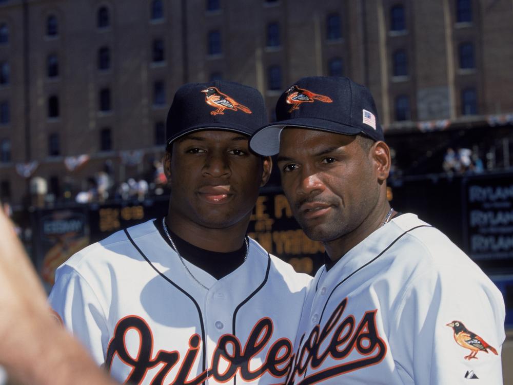 Baltimore Orioles left fielder Tim Raines Sr. poses with his son and teammate, center fielder Tim Raines Jr., before an October 2001 game.
