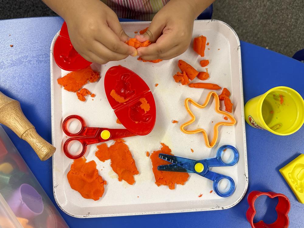 Beck and her longtime assistant sneak lessons into all kinds of activities, including using Play-Doh to practice letter sounds.