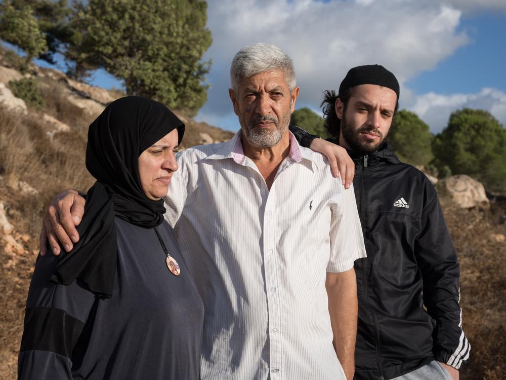 The parents and brother of Palestinian-American Mohammad Khdour stand in the outskirts of Biddu, the West Bank, on Sept. 19. Mohhamad, 17, was shot while he was driving in the hills not far from their home in February.