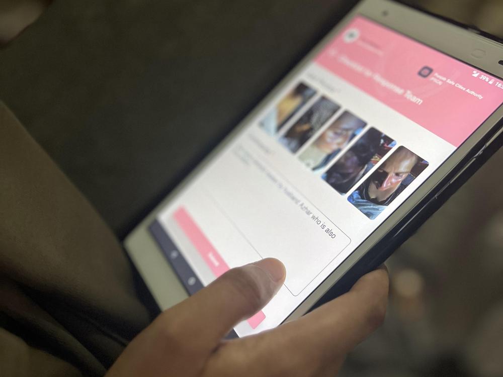A member of the Pink Wheels team types a complaint into their app.