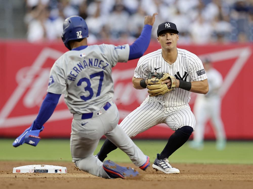 Anthony Volpe of the New York Yankees looks to complete a 2nd-inning double play after forcing out Teoscar Hernández of the Los Angeles Dodgers at Yankee Stadium on June 7 in New York City.