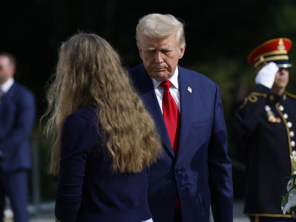 Former President Donald Trump stands alongside appears at a wreath laying ceremony at the Tomb of the Unknown Soldier at Arlington National Cemetery on August 26.
