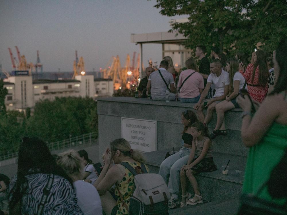 As evening falls on Aug. 14, people gather on the Potemkin Stairs, a well-known meeting place and venue for street musicians. The city's port can be seen in the distance.