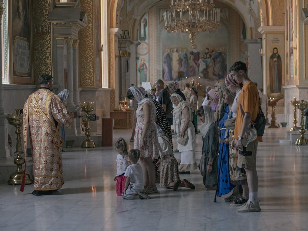 In the Cathedral of the Transfiguration of Our Lord, damaged in a Russian missile strike last summer, services take place in one of the small chapels, seen here on Aug. 17, a testament to the community's enduring faith.