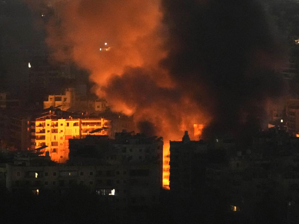Flame and smoke rises from buildings hit by Israeli airstrikes on Dahiyeh, in the southern suburb of Beirut, Lebanon, early Sunday, Oct. 27, 2024.