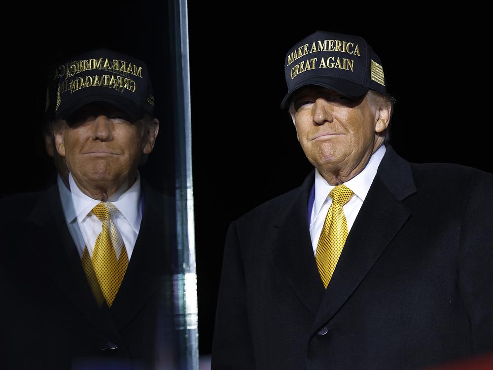 Republican presidential nominee, former President Donald Trump arrives for a campaign rally at in Traverse City, Mich., on Friday. Trump recorded the Joe Rogan Experience podcast earlier Friday and delayed his Michigan appearance by three hours.