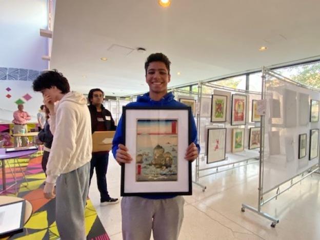 University of Chicago student Rudra Patel happily shows off the work of famed artist Ando Hiroshige that he'll get to display in his dorm room for one year.  Hiroshige was a master of Japanese woodblock printing whose work focused on landscapes and everyday life in Edo-period Japan.