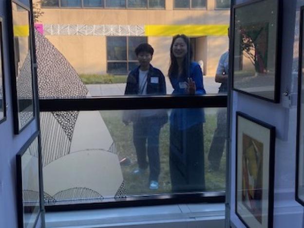 Students near the end of the line peek in through the museum's windows to see what choices are left.