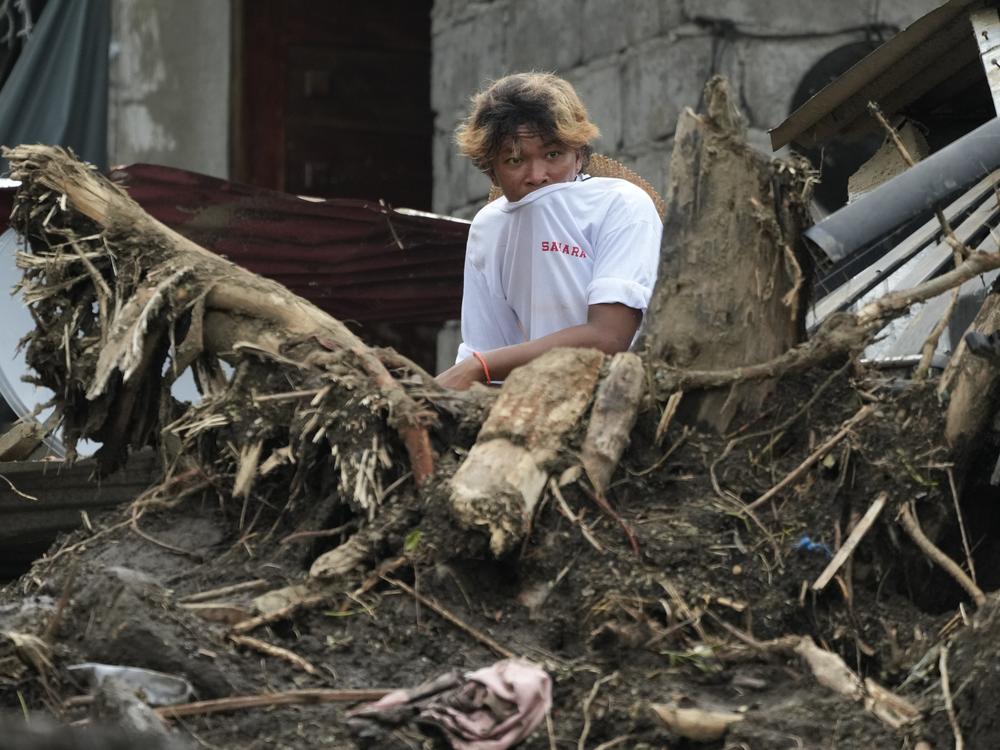 A villager watches rescue operations after a recent landslide triggered by Tropical Storm Trami struck Talisay, Batangas province, Philippines leaving thousands homeless and several villagers dead on Saturday, Oct. 26, 2024.
