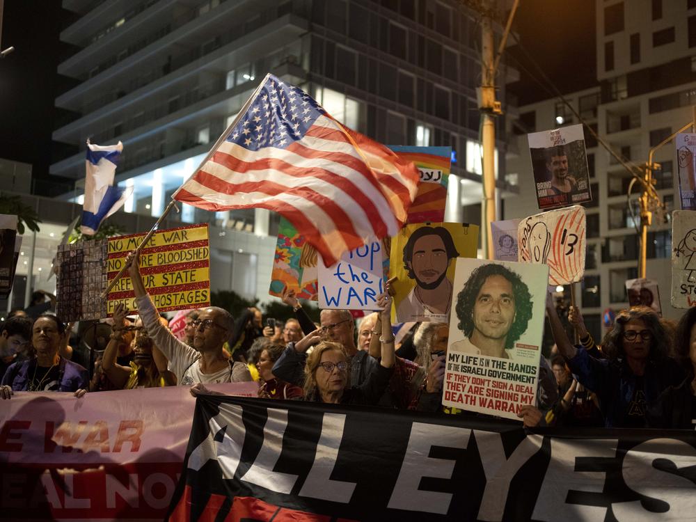 Relatives of Israelis held hostage by Hamas in the Gaza Strip and their supporters protest outside the hotel where Secretary of State Antony Blinken was staying during a visit with Israeli leadership, in Tel Aviv, Oct. 22.