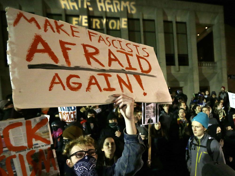 A protester holds a sign that reads 
