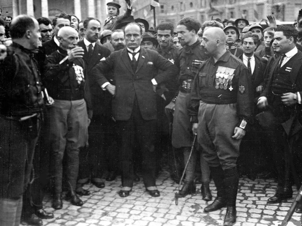 Italian Fascist leader Benito Mussolini, center, hands on hips, with members of the Fascist Party, in Rome, Italy, on Oct. 28, 1922.