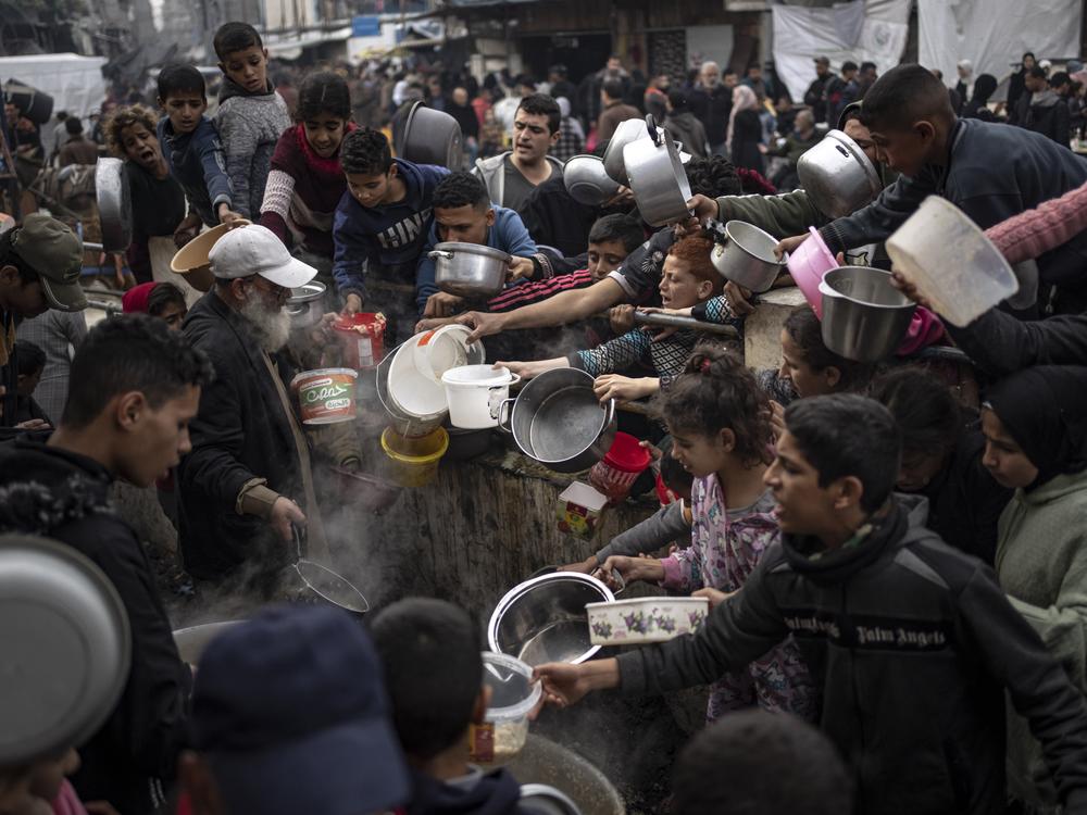 Palestinians are seen lining up for a meal in Rafah, Gaza Strip, on Dec. 21, 2023.