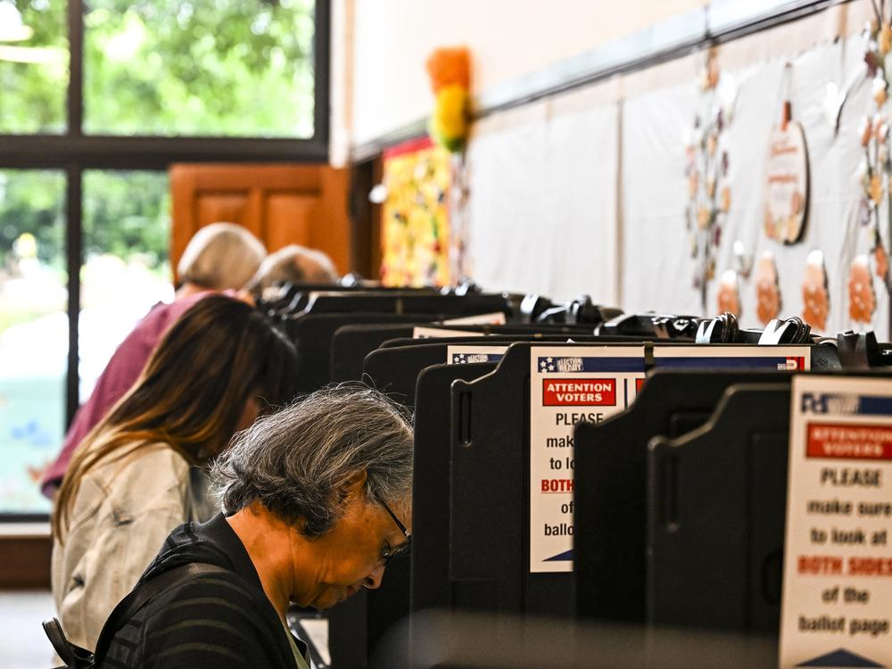 Voters cast their ballots at a library in Coral Gables, Fla., on Oct. 21.