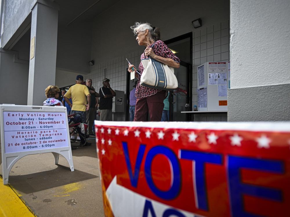 A person leaves an early voting site after casting a ballot on Oct. 21 in Deland, Fla. Florida is one of three states that recently sued the Biden administration over citizenship checks of voters.