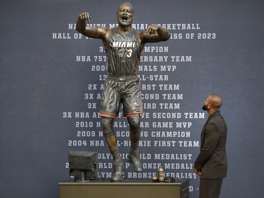 Former Miami Heat NBA basketball player Dwyane Wade looks at a bronze statue of his likeness during its unveiling ceremony outside the Kaseya Center in Miami, Fla. on Oct. 27.