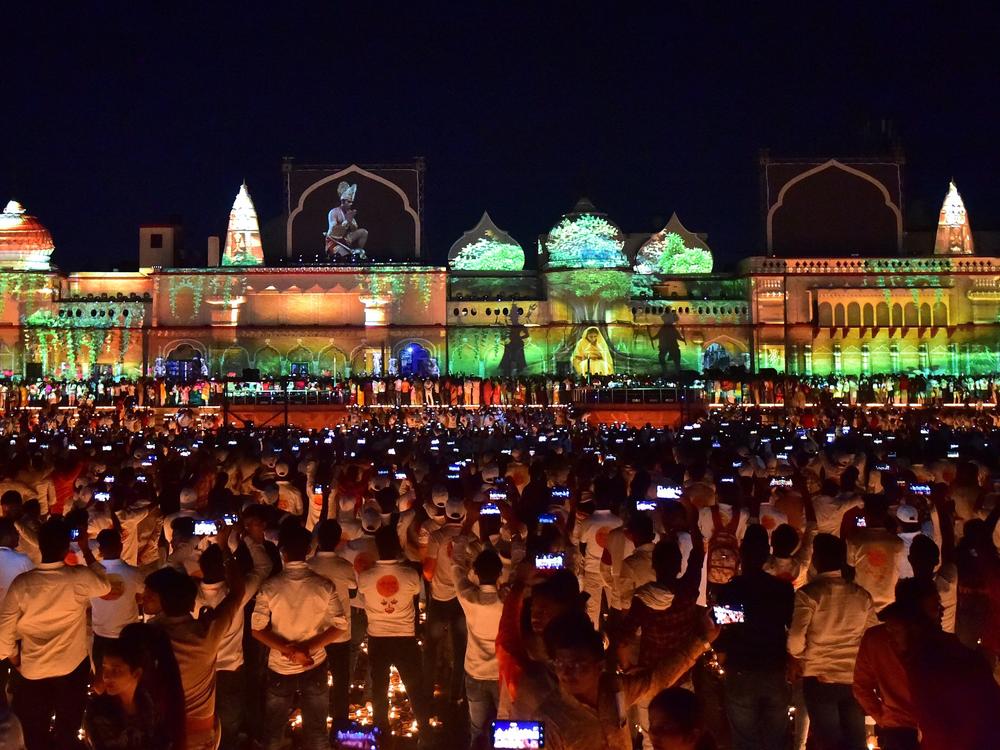 People watch a light show on the banks of river Sarayu on the eve of Diwali, the Hindu festival of lights, in Ayodhya on Oct. 23, 2022.