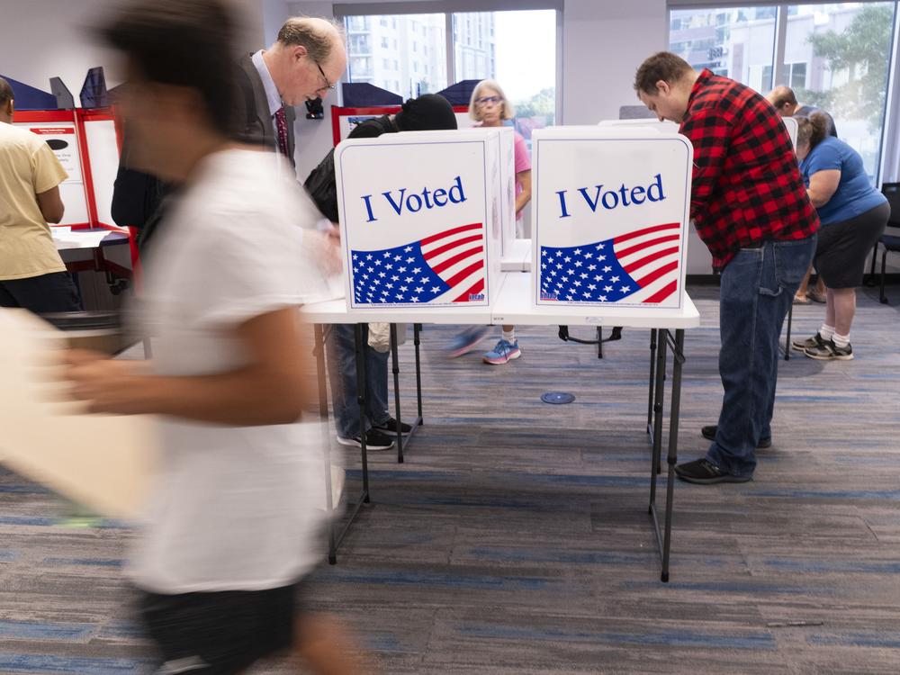 Voters work on their ballots at a polling station in Arlington, Va., on Sept. 20.