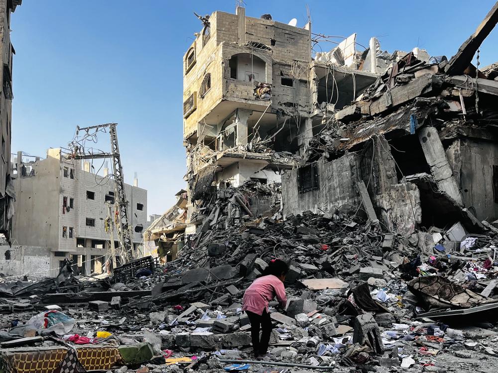 A Palestinian girl searches in the rubble of a building after an Israeli strike in Beit Lahiya, in the northern Gaza Strip, on Tuesday.