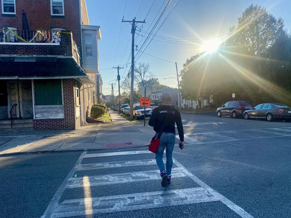 UNITE HERE canvasser Wernel Martinez crosses a street in the Philadelphia suburb of Norristown after a long day of knocking on voters' doors.
