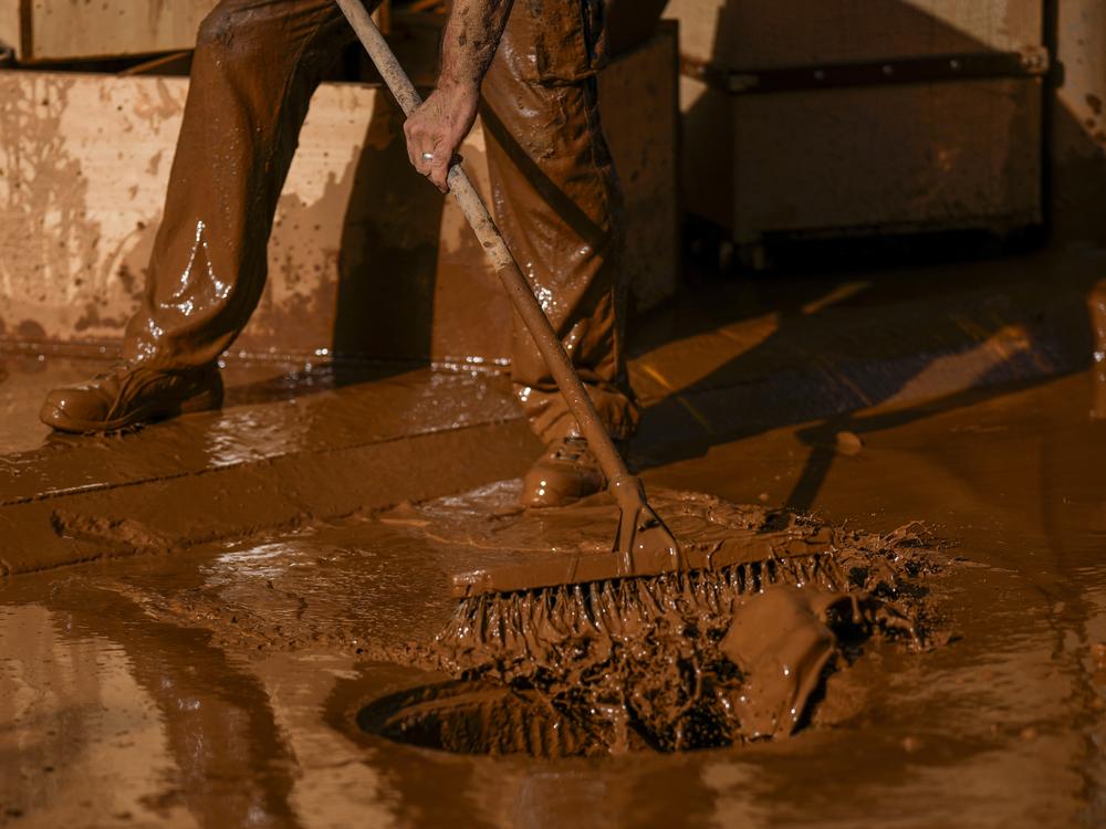 A person removes mud after the floods in Utiel, Spain on Wednesday.