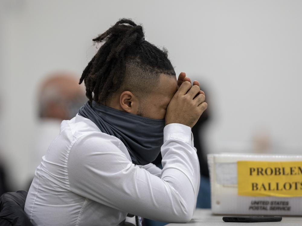 A worker with the Detroit Department of Elections takes a break after sorting through absentee ballots at the TCF Center on Nov. 4, 2020.
