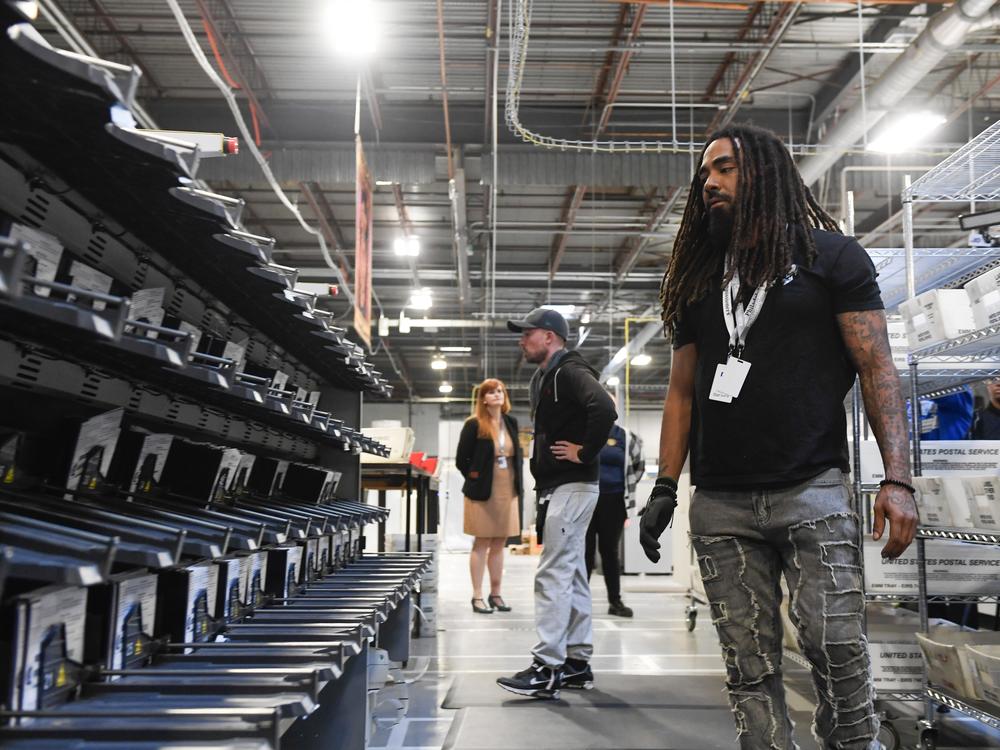 Ahead of Election Day, poll workers demonstrate how ballots are received, processed, scanned and stored in an election warehouse in Philadelphia.
