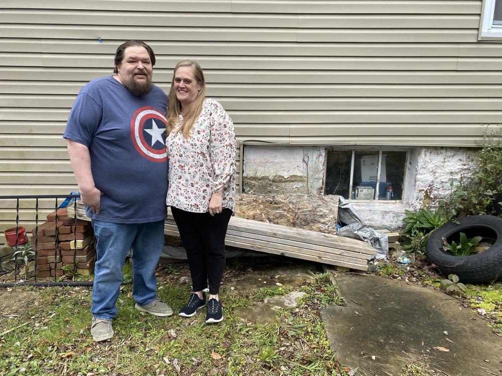 Robert and Melissa Cox stand outside their home in Glen Campbell, Pa., on Oct. 16.  Even though they've made a series of repairs over the years, the home still has multiple problems — including an eroding foundation.