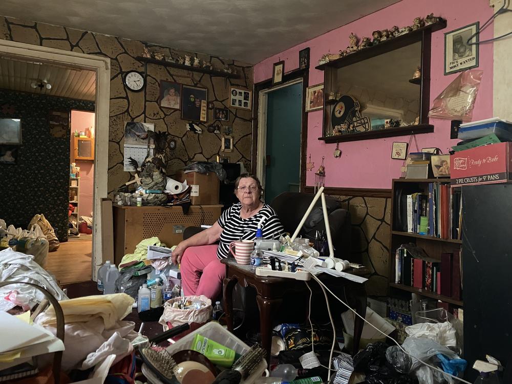 Velma Fishel sits in the living room of her home in Glen Campbell, Pa., on Oct. 16. The house was built in 1890, and a few years ago, Fishel was shocked to look up and see the walls separating from the ceiling. The room is full of items moved from the back of the house ahead of the needed repairs.