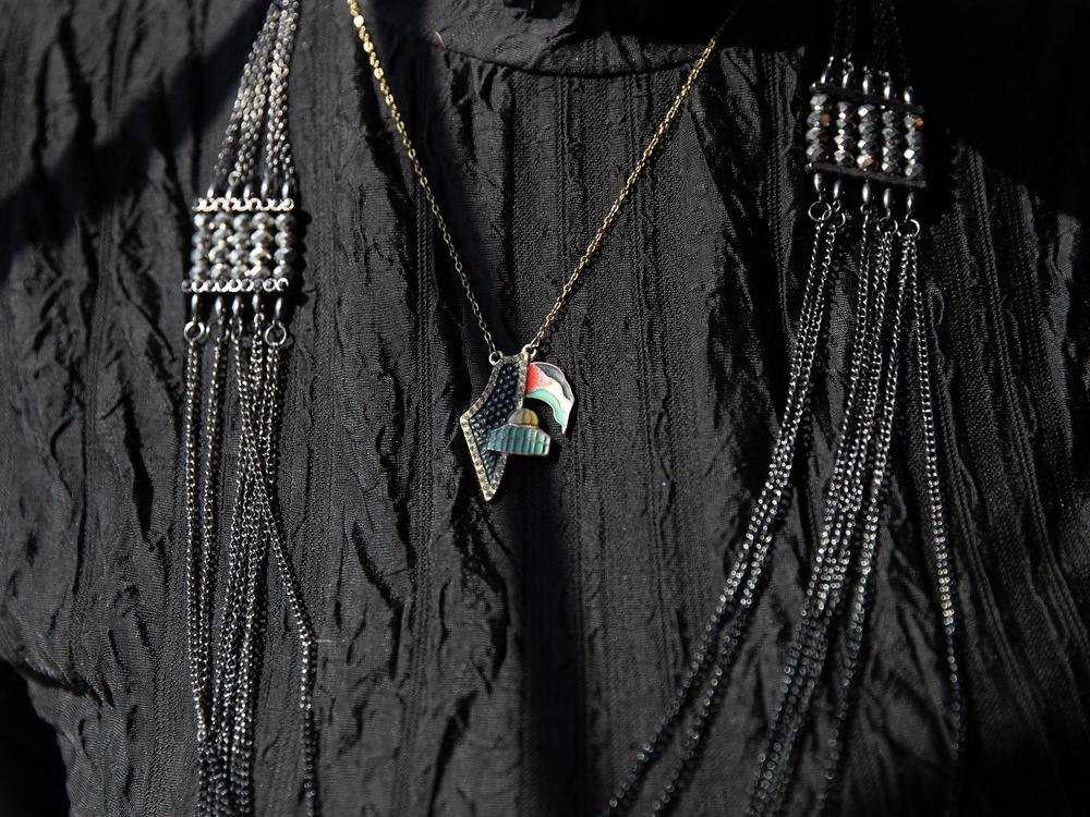 Luqman wears a necklace featuring the Palestinian flag.