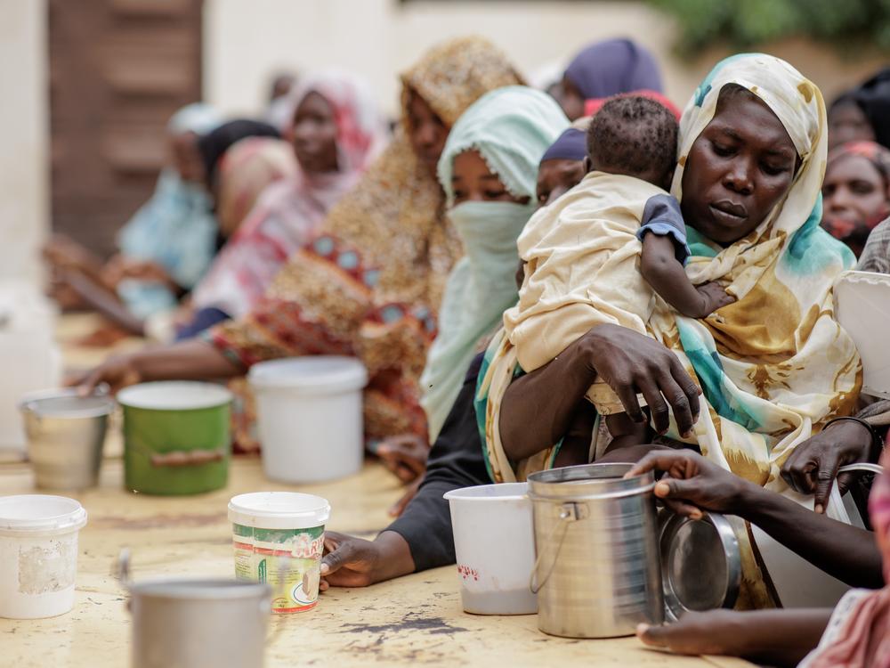 Women receive food from Friday Meals Sharing Kitchen in Omdurman, Sudan, on Sept. 6.