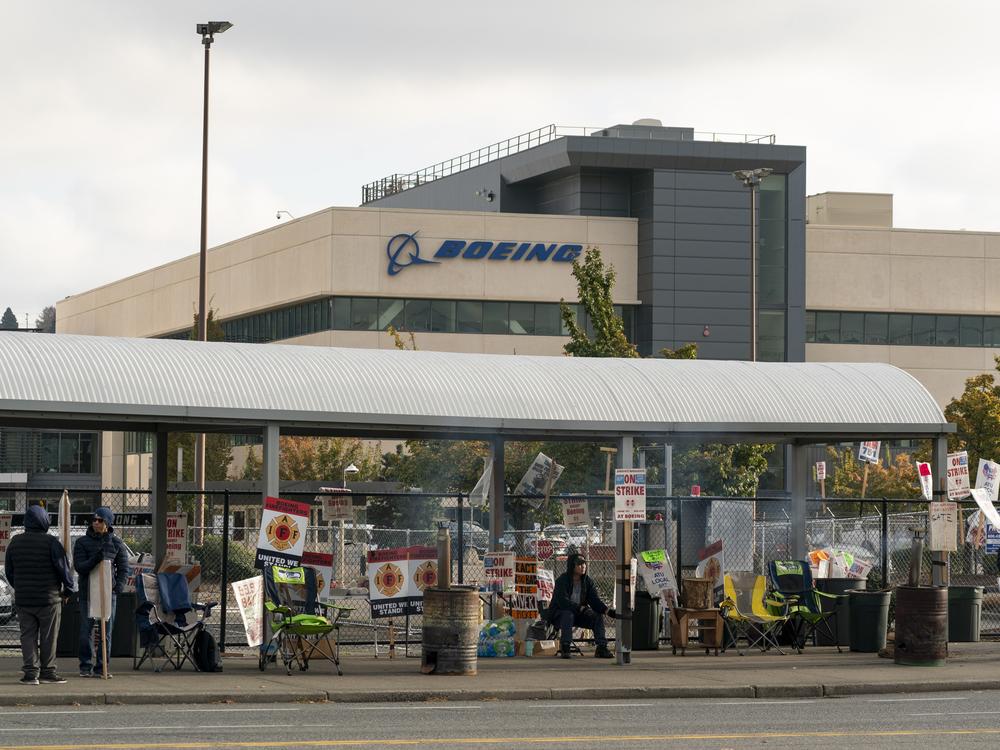 Boeing workers gather on a picket line near the entrance to a Boeing facility during an ongoing strike in Seattle, Wash. About 33,000 members of the International Association of Machinists and Aerospace Workers District 751 have been on strike for nearly seven weeks.
