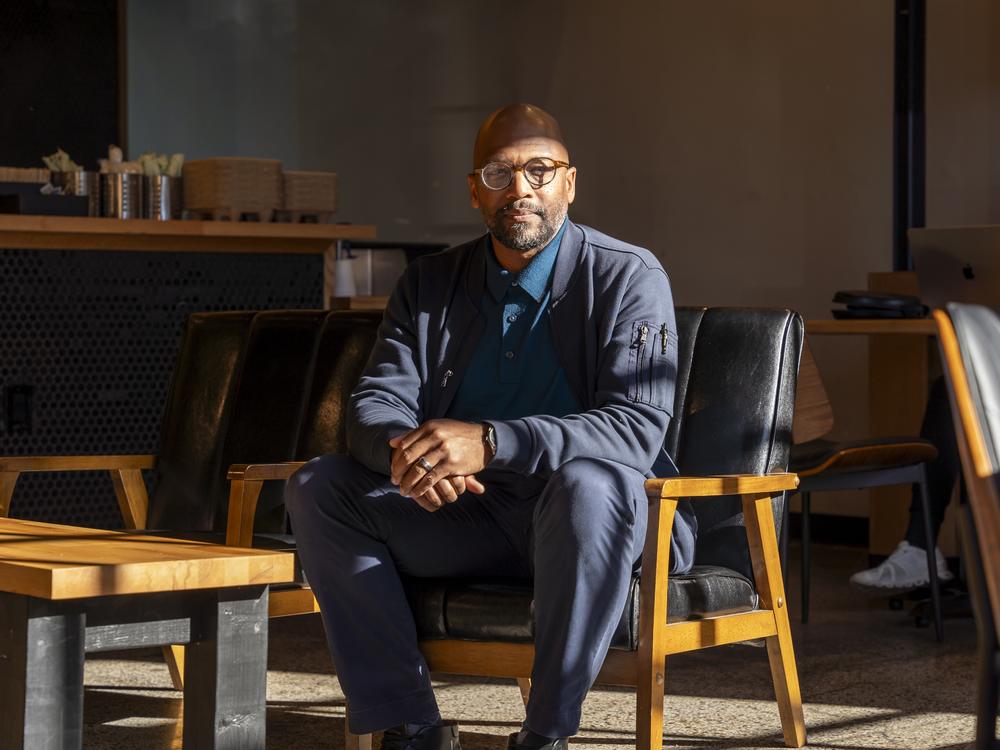 Imam Mika'il Stewart Saadiq sits inside Kitab Cafe in Detroit on Oct. 10. He is one of 25 American imams from across the country who endorsed Harris in an open letter.<br>