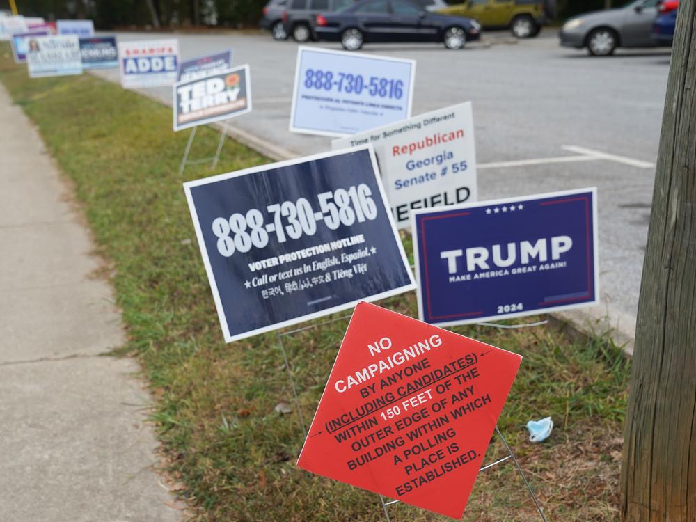 Signs sit outside of a polling location on the last day of early voting for the 2024 election on Friday in Clarkston, Ga.