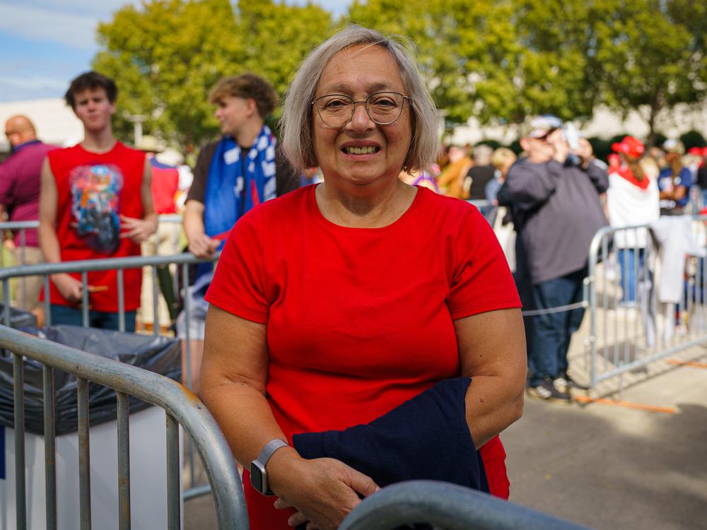 Daniela Usurin waits in line for a Trump campaign rally in Atlanta on Oct. 15, 2024. She says immigration and inflation are driving her vote.
