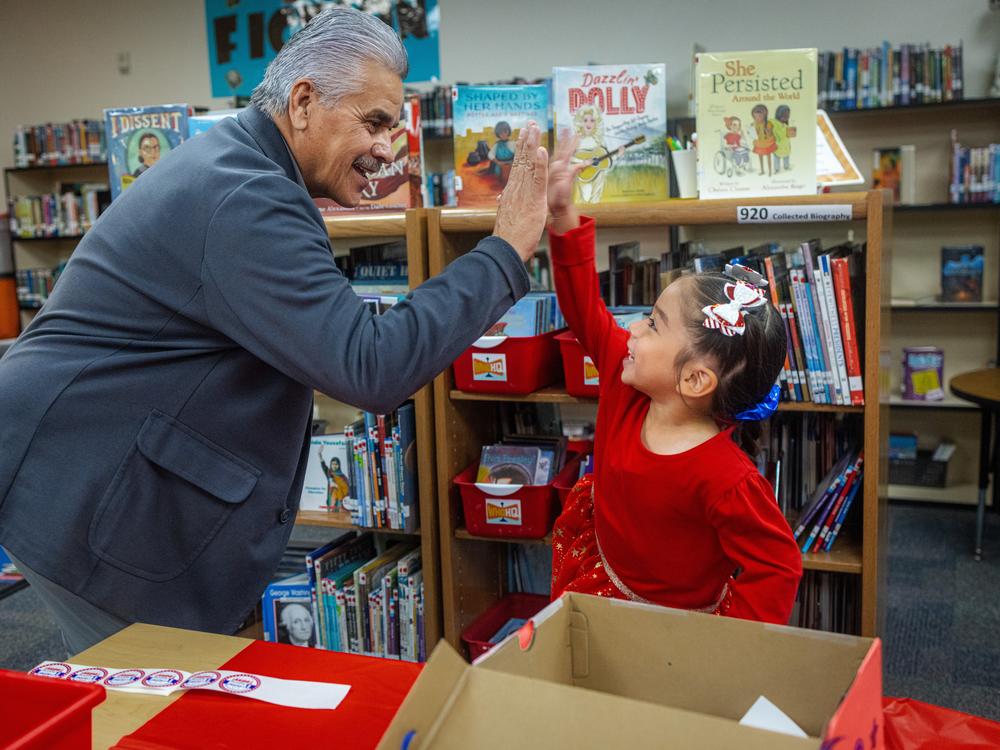Tribal Council President Martin Harvier greets each student with stickers and high-fives as they drop their ballots into a box.