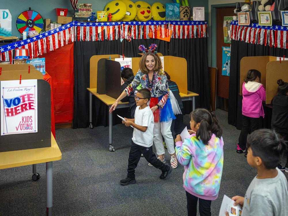 Meyers guides students to privacy booths where they can cast their ballot.
