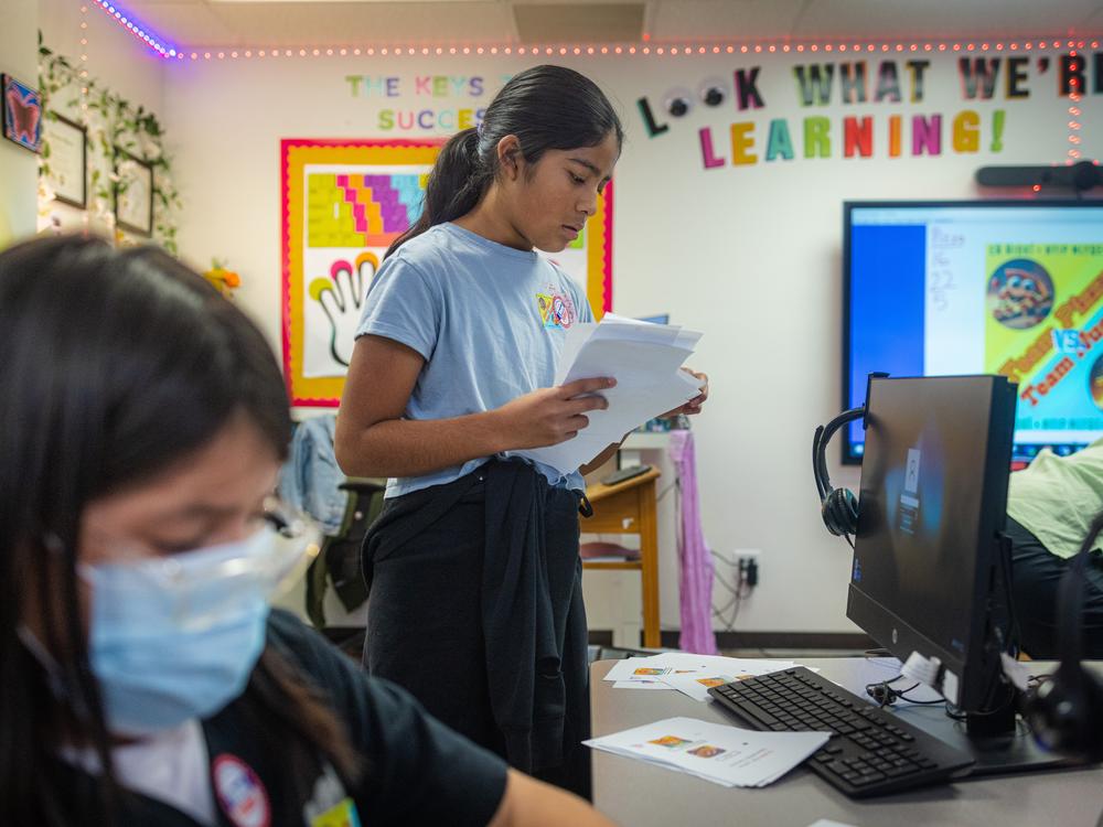Sixth grader Stephanie Mainez, vice president of the student council, counts a stack of ballots.