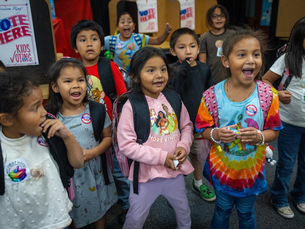 Students react as the school principal announces the winner: It's pizza!