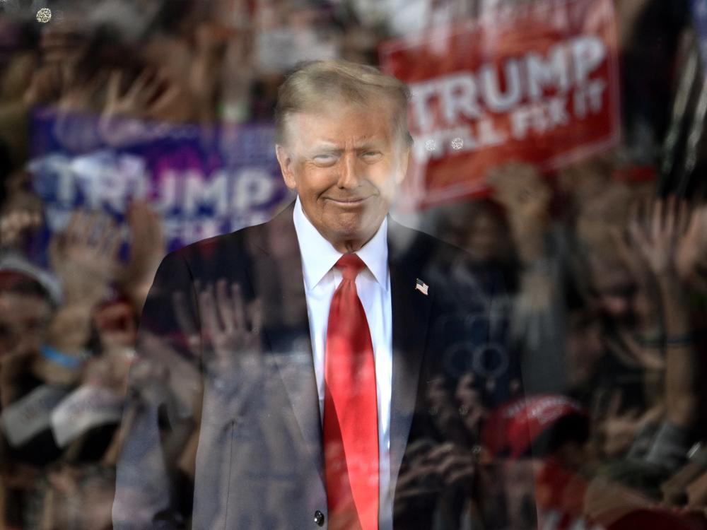 Behind bulletproof glass, former President Donald Trump arrives to speak during a campaign rally in Gastonia, North Carolina, on Saturday.