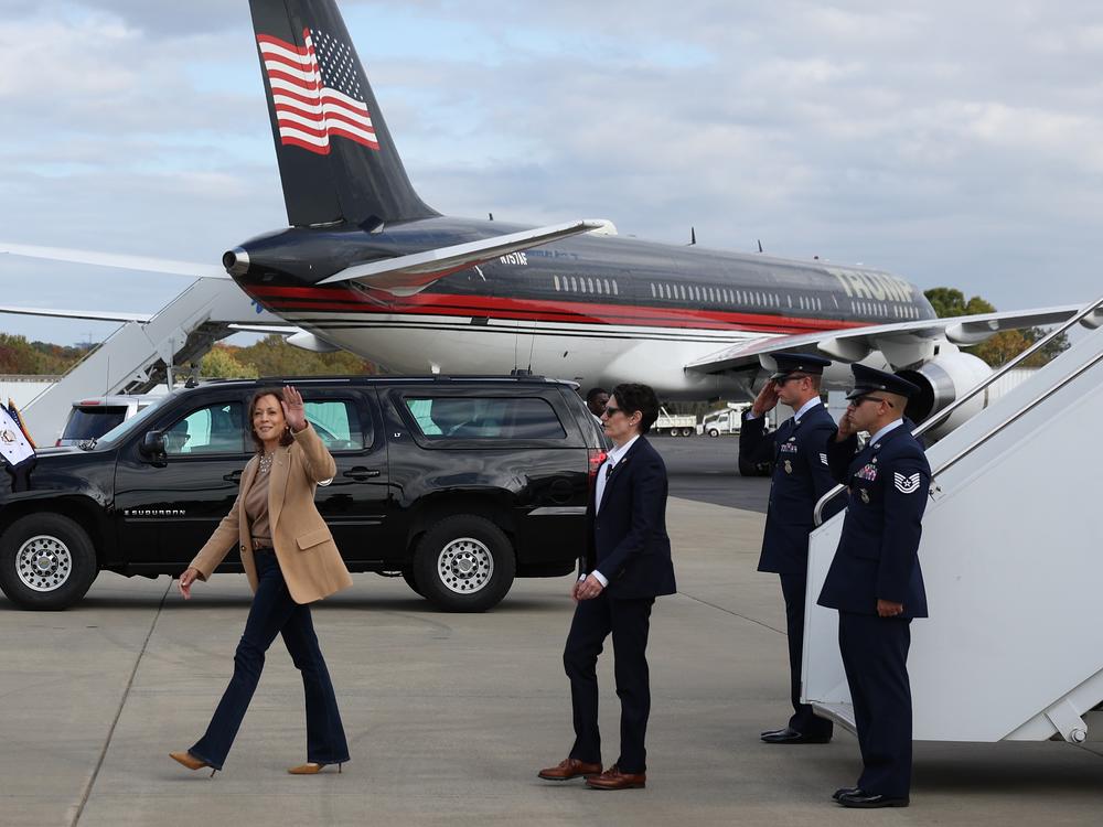 Democratic presidential nominee, Vice President Harris, arrives at Charlotte Douglas International Airport next to the airplane of Republican presidential nominee, former President Donald Trump, on Saturday. Both candidates are in the pivotal state of North Carolina to close out their presidential campaigns.