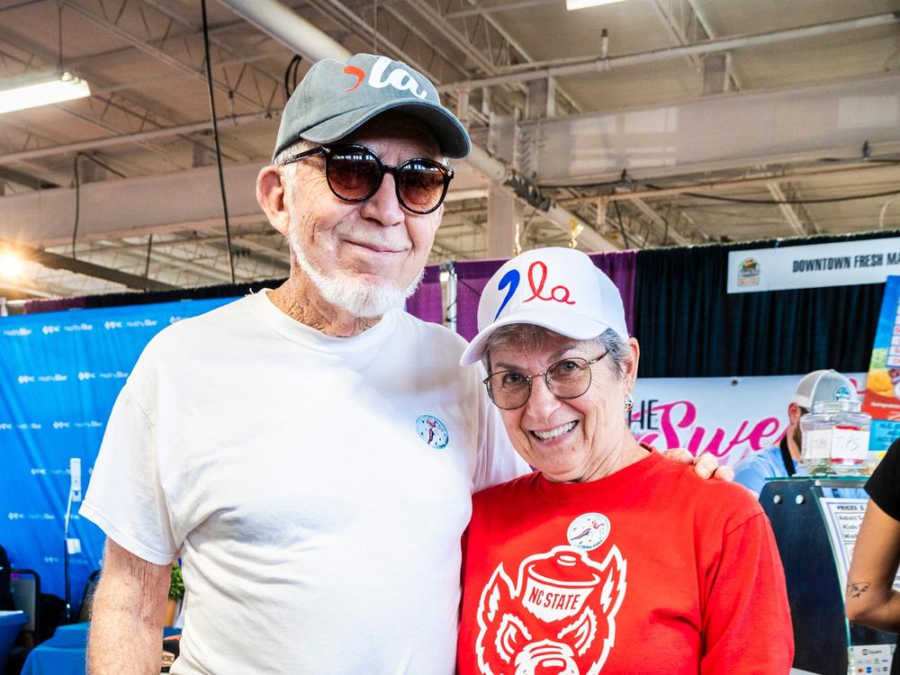 Lew and Debbie Love show off their homemade hats supporting Harris.