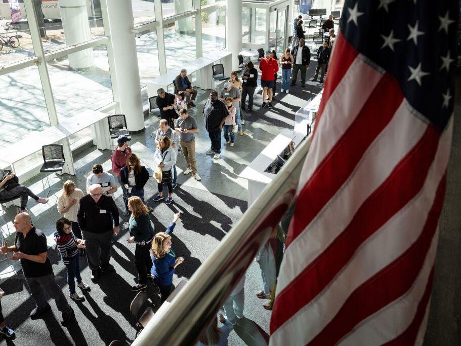 Voters line up to cast their ballots at the Stamford Government Center on the first day of early voting on Oct. 21 in Stamford, Conn.