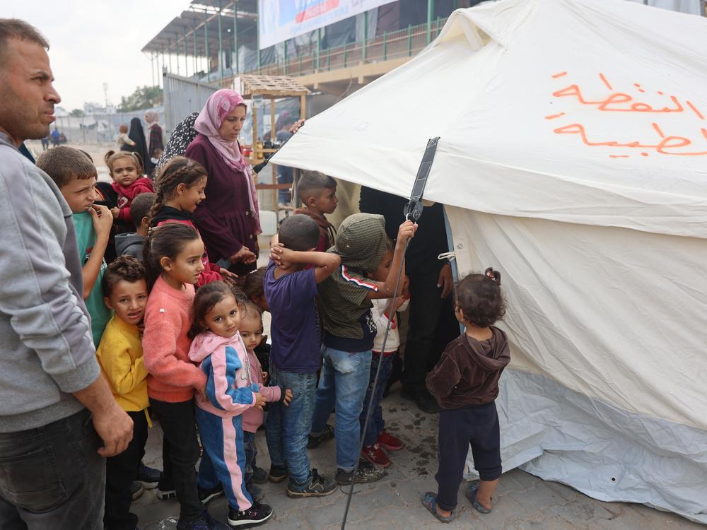 Palestinian children queue outside a tent for the second phase of polio vaccination at Abdel Aziz Rantissi hospital in Gaza City's Nasr district on Saturday.