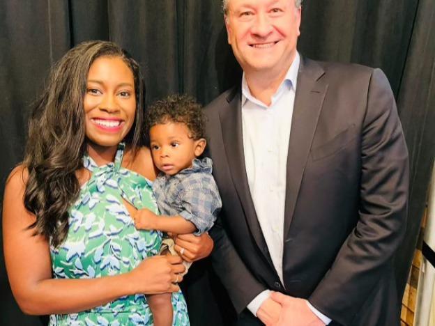 Kaitlyn Joshua and her son, Liam, pose with Second Gentleman Doug Emhoff during a rally for then-candidate President Joe Biden in Clawson, Michigan on June 24, 2024.