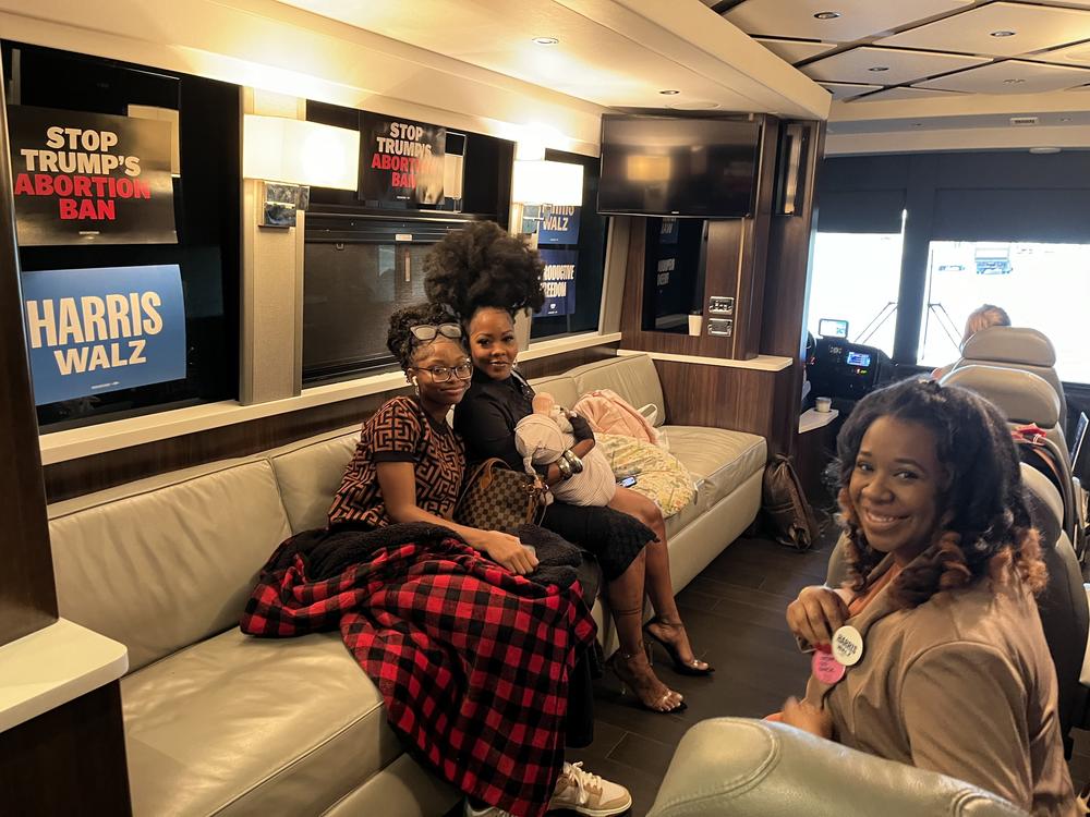 Nancy Davis rests for a moment with her daughters Asia (left) and Starr (in arms) inside the Fighting for Reproductive Freedom tour bus on Sept. 23, 2024 in Michigan.